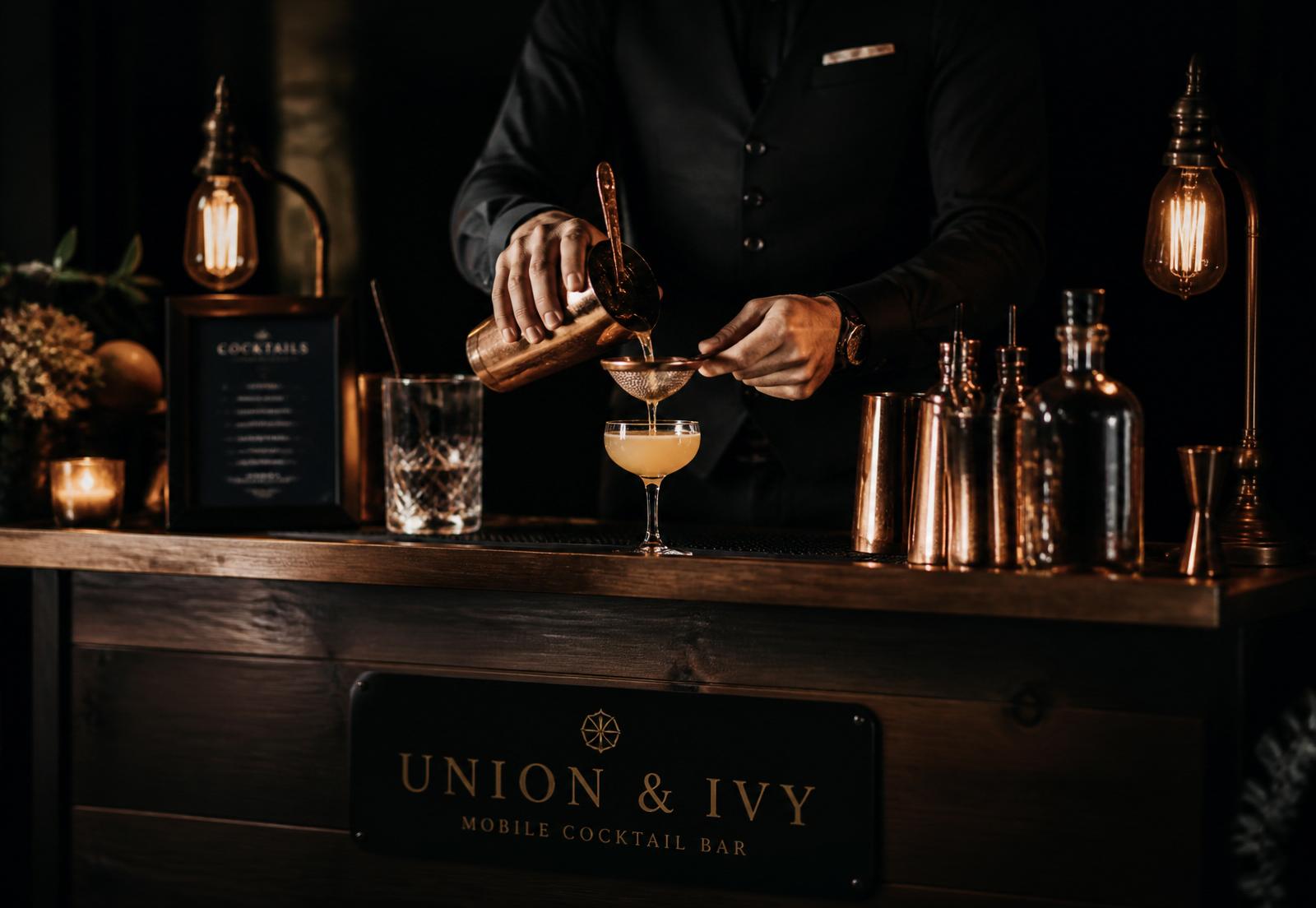 Bartender straining a cocktail at a candlelit mobile bar